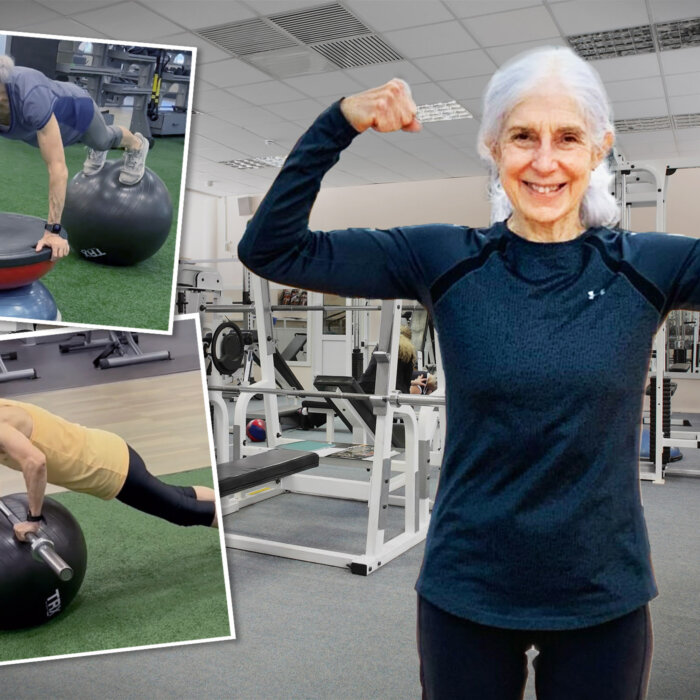 Cheerful senior woman gesturing thumbs up with people exercising in the  background at fitness studio - Foot & Leg Centre