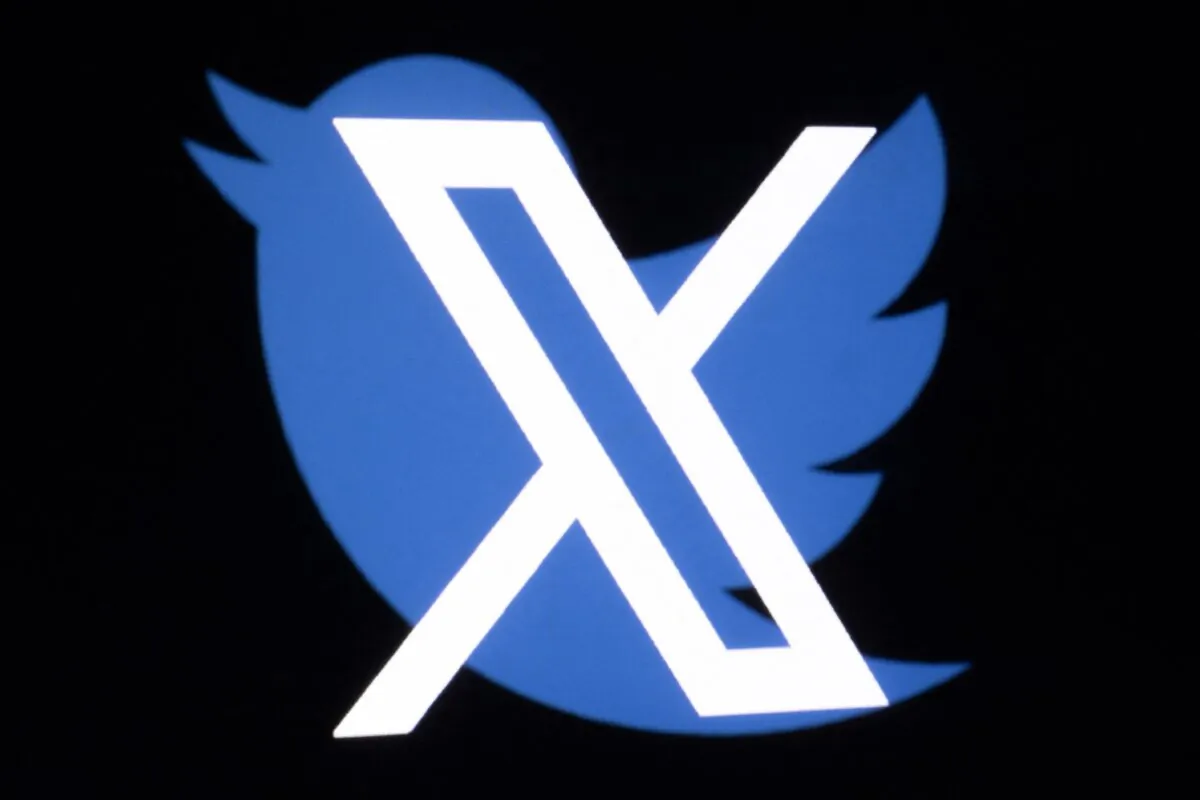 The new Twitter logo rebranded as X, and the old Twitter bird logo reflect in smartphone screens in Paris, France, on July 27, 2023. (Joel Saget/AFP via Getty Images)