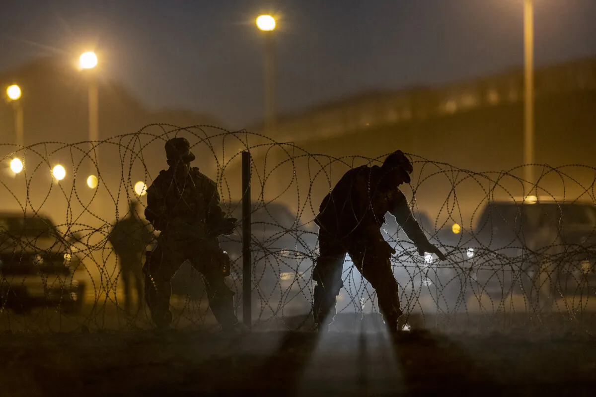 Texas National Guard troops set up razor wire near hundreds of immigrants who had crossed into the United States from Mexico on May 9, 2023 in El Paso, Texas. (John Moore/Getty Images)
