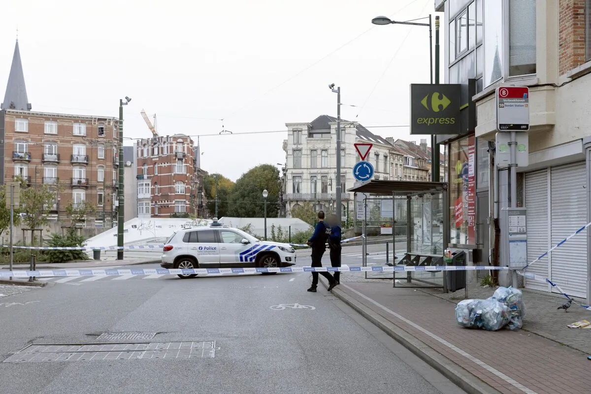 Police officers stand guard near the Eugene Verboekhovenplein in the Schaerbeek area of Brussels on Oct. 17, 2023, where the suspected perpetrator of the attack in Brussels was probably shot during a police intervention in a cafe. (JAMES ARTHUR GEKIERE/BELGA/AFP via Getty Images)