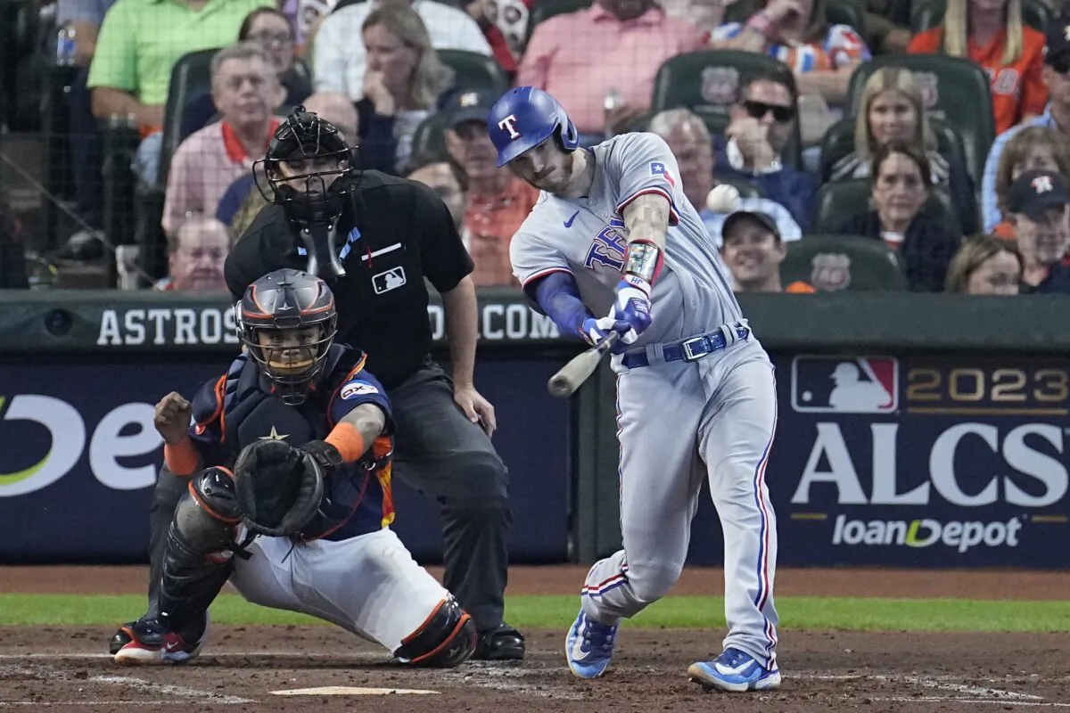 Texas Rangers' Jonah Heim hits a home run during the third inning of Game 2 of the baseball AL Championship Series against the Houston Astros in Houston Oct. 16, 2023. (Tony Gutierrez/AP Photo)