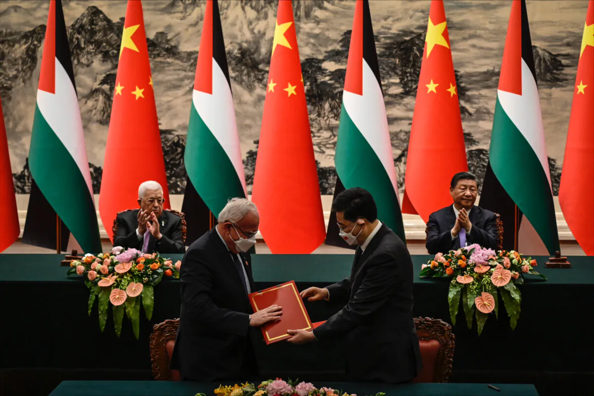 Palestinian Foreign Minister Riyad Al-Maliki (front L) attends a signing ceremony with then-Chinese Foreign Minister Qin Gang (front R) as Palestinian President Mahmoud Abbas (rear L) and Chinese leader Xi Jinping (rear R) applaud at the Great Hall of the People in Beijing on June 14, 2023. (Jade Gao/Pool/Getty Images)