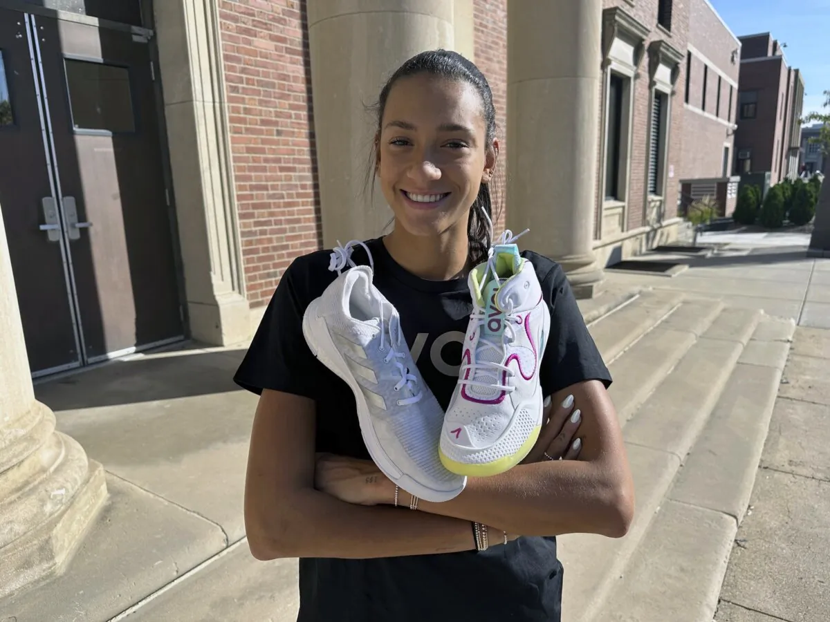 University of Nebraska volleyball player Harper Murray poses with her Avoli (R) and Adidas (L) volleyball shoes on the school campus in Lincoln, Neb., on Oct. 8, 2023. (Eric Olson/AP Photo)