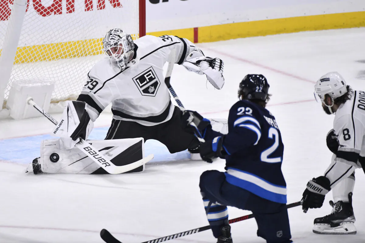 Los Angeles Kings goaltender Cam Talbot makes a save on Winnipeg Jets center Mason Appleton (22) during the first period of an NHL hockey game in Winnipeg, Manitoba, Oct. 17, 2023. (Fred Greenslade/The Canadian Press via AP)