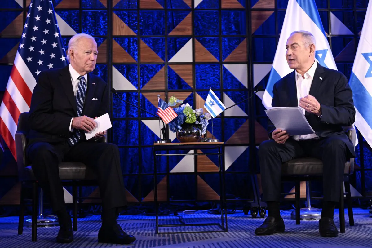 U.S. President Joe Biden (L) listens on as Israel's Prime Minister Benjamin Netanyahu reads a statement before their meeting in Tel Aviv on Oct. 18, 2023. (Brendan Smialowski/AFP via Getty Images)