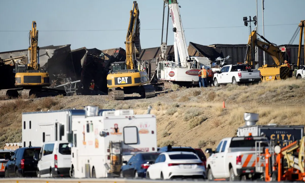 Workers toil to clear cars that derailed in an accident over Interstate 25 northbound, north of Pueblo, Colo., on Oct. 16, 2023. (David Zalubowski/ AP Photo)