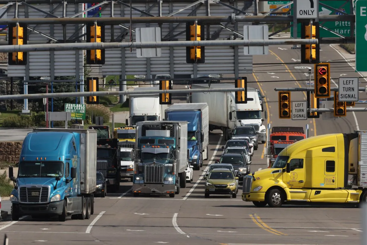 Semi-trailer trucks move along Lincoln Highway while using the indirect interchange from Interstates 70, the Pennsylvania Turnpike and U.S. Route 30, in Breezewood, Pa., on Oct. 14, 2021. (Chip Somodevilla/Getty Images)