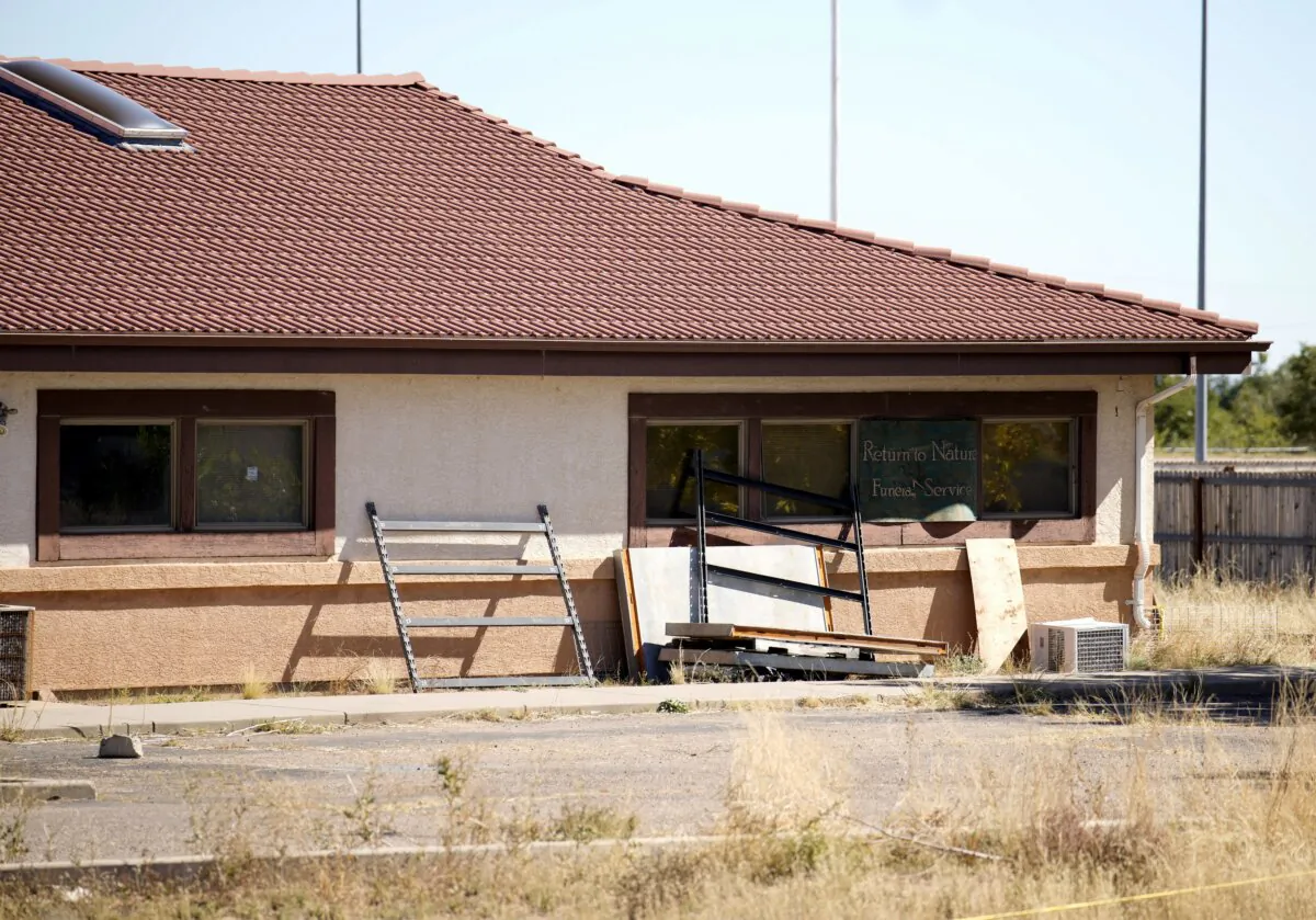 A sign covers the broken back window of the Return to Nature Funeral Home in Penrose, Colo., on Oct. 16, 2023. (David Zalubowski/AP Photo)