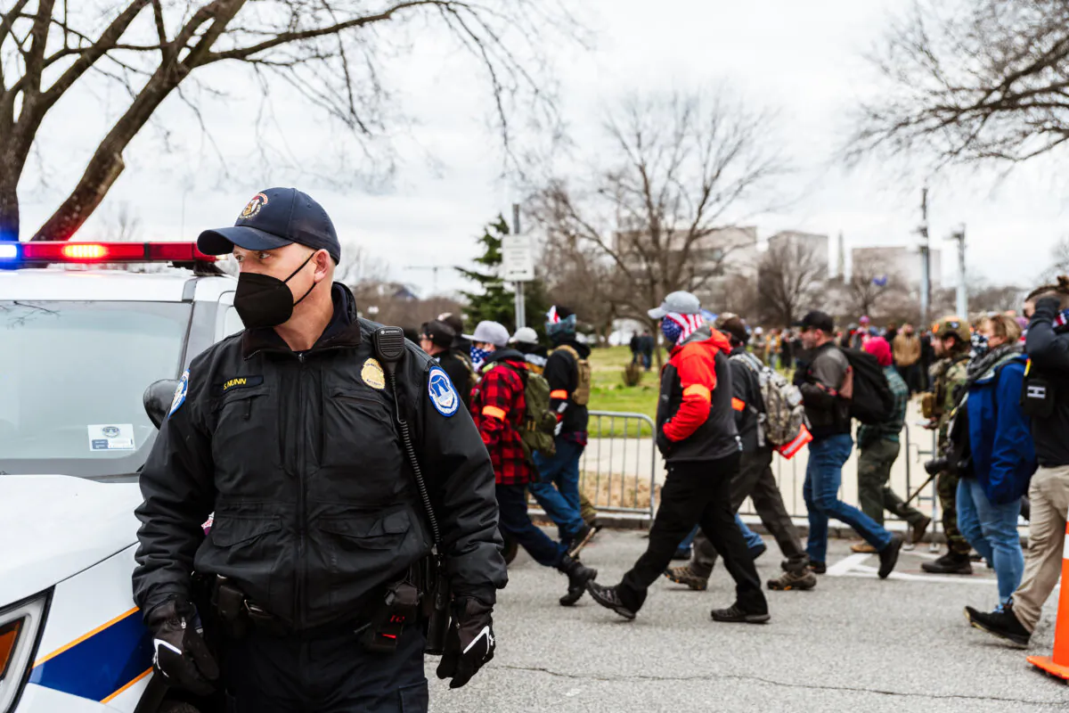 A U.S. Capitol Police officer watches as pro-Trump protesters march in front of the U.S. Capitol Building on Jan. 6, 2021, in Washington D.C. (Jon Cherry/Getty Images)