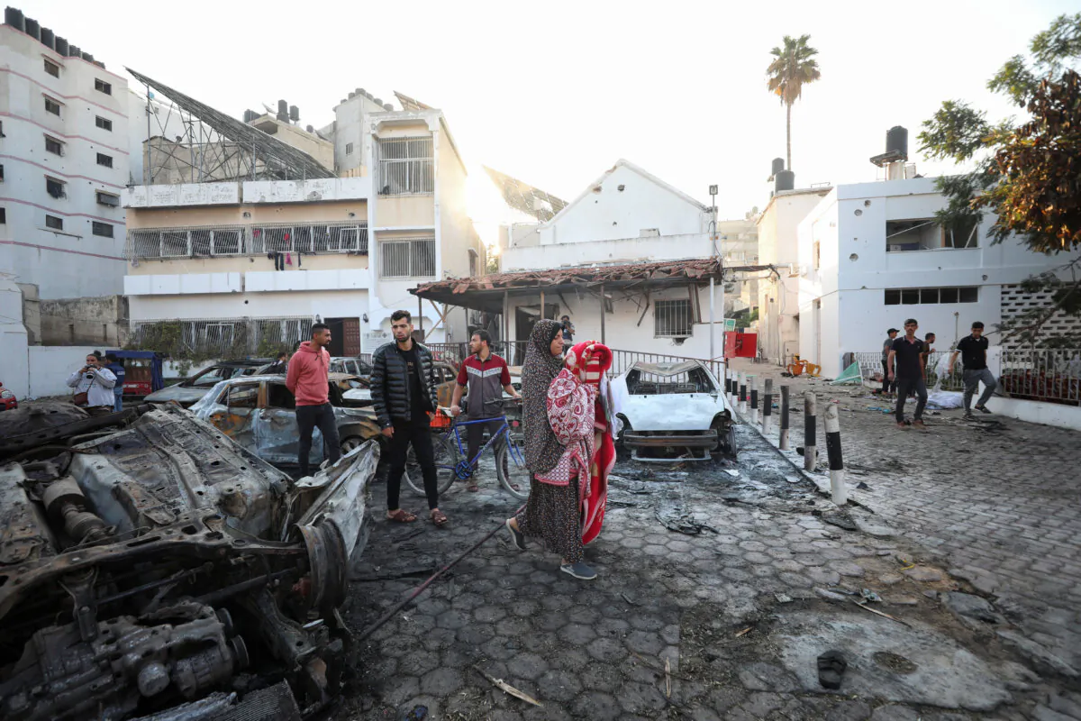 People inspect the area of Al-Ahli hospital in Gaza City on Oct. 18, 2023, after a blast the previous day. (Mohammed Al-Masri/Reuters)