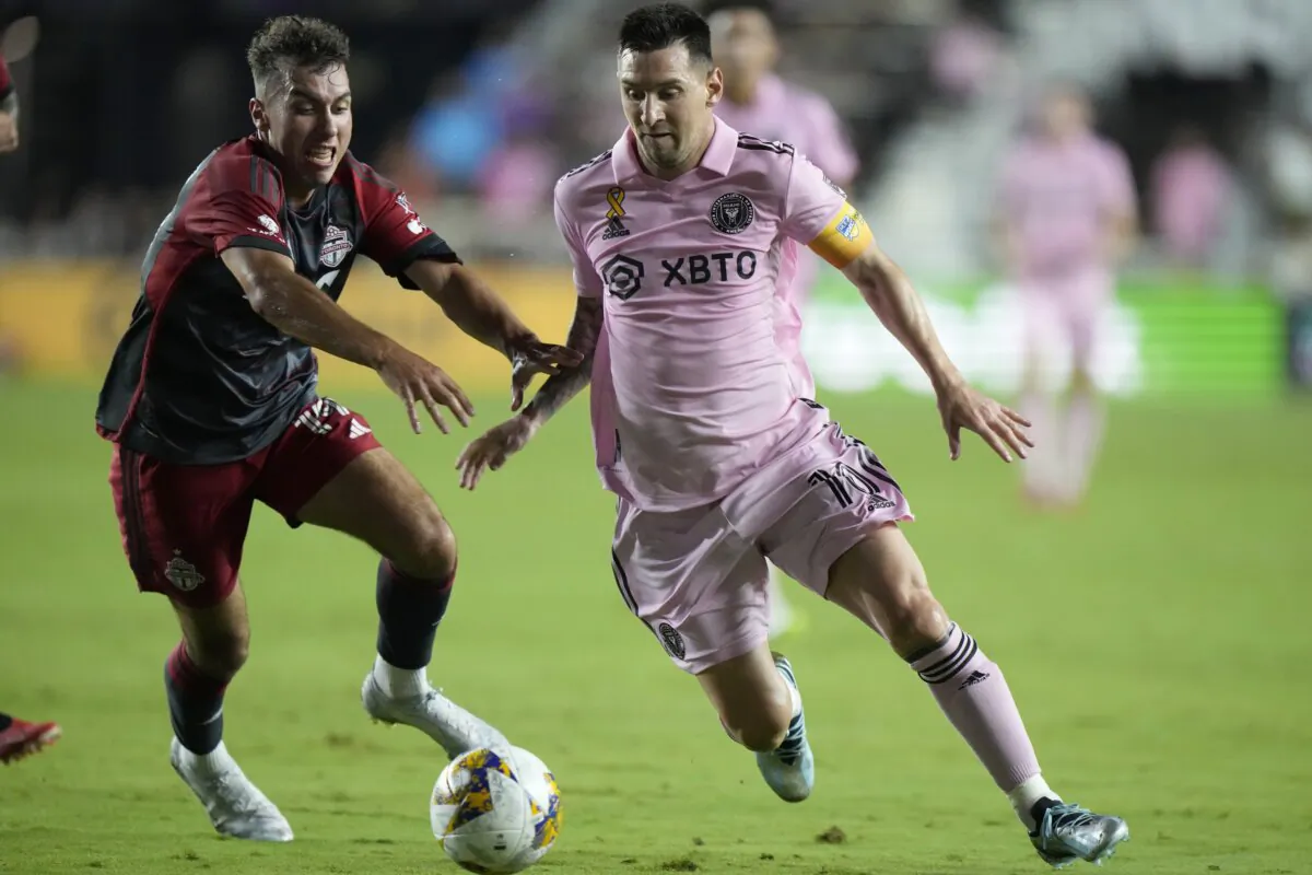 Inter Miami forward Lionel Messi (R) takes the ball past Toronto FC defender Kobe Franklin during the first half of an MLS soccer match in Fort Lauderdale, Fla., on Sept. 20, 2023. (Wilfredo Lee/AP Photo)