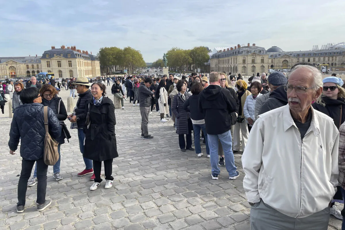 Tourist wait outside The Palace of Versailles in Versailles, France, on Oct. 17, 2023. (Pat Eaton-Robb/AP Photo)
