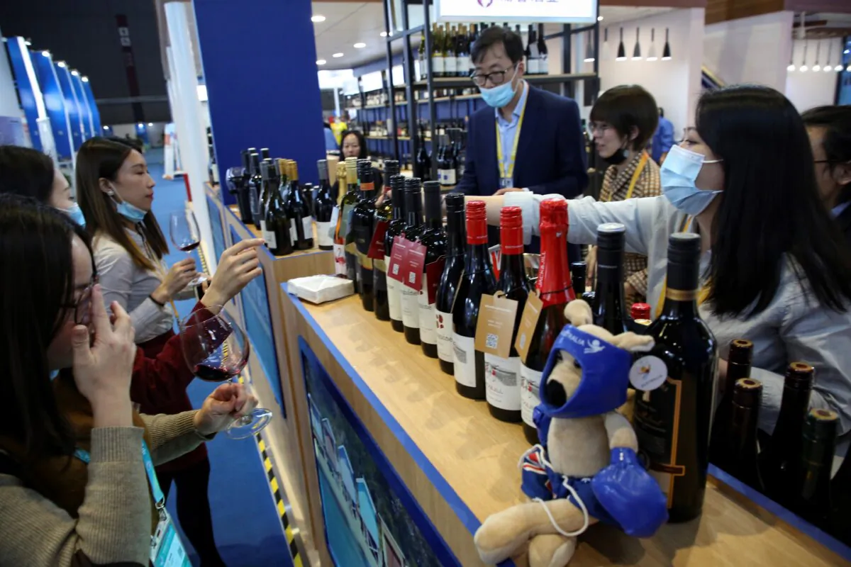 People taste red wine from Australia at the Food and Agricultural Products exhibition in Shanghai, China on Nov. 5, 2020. (STR/AFP via Getty Images)