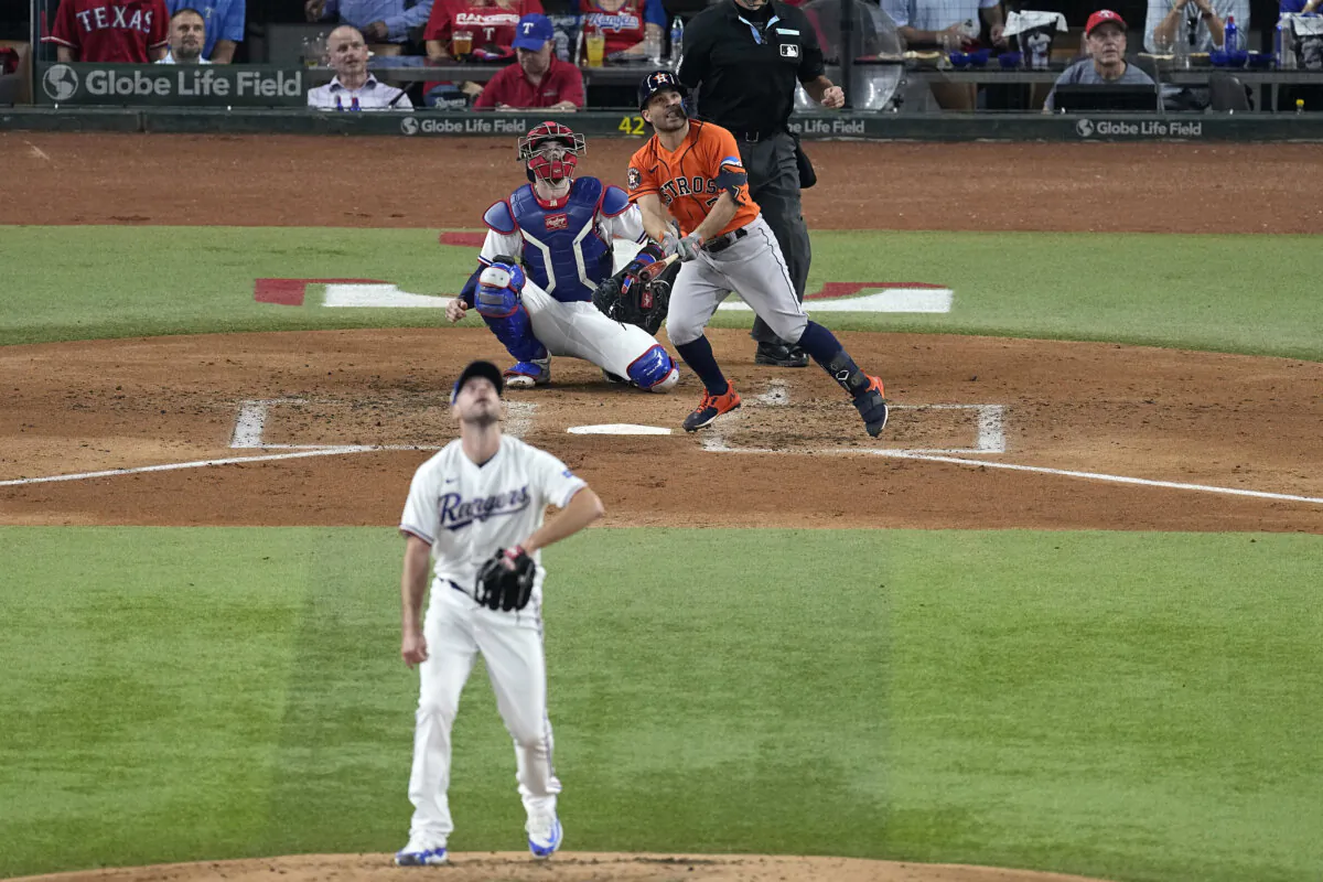 Houston Astros' Jose Altuve (27) hits a home run off Texas Rangers starting pitcher Max Scherzer, bottom, during the third inning in Game 3 of the baseball American League Championship Series in Arlington, Texas, on Oct. 18, 2023. (Tony Gutierrez/AP Photo)