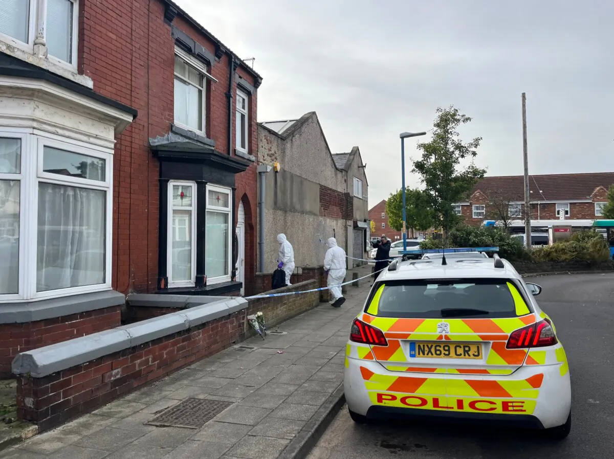 Police officers investigating a murder and an attempted murder enter a house at Wharton Terrace in Hartlepool, England on Oct. 16, 2023. (PA)