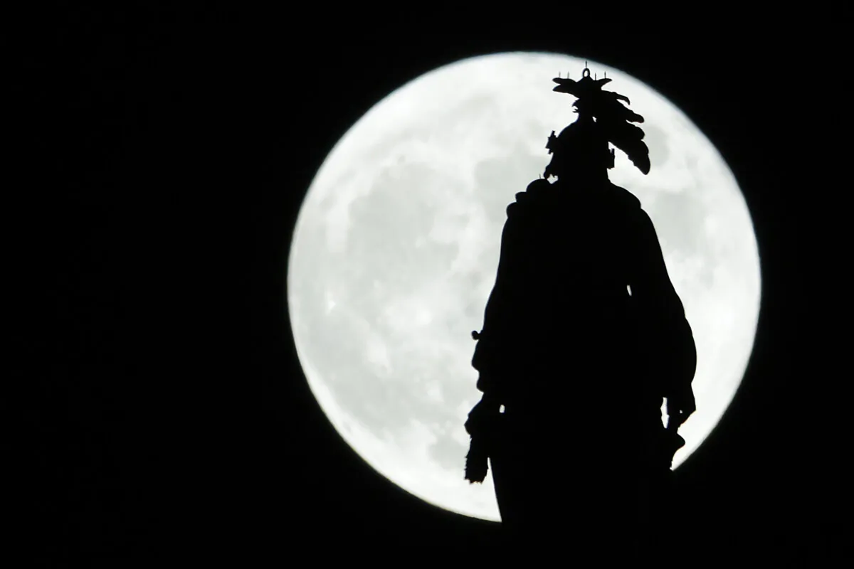 The Hunter’s Moon rises behind The Statue of Freedom that crowns the U.S. Capitol dome in Washington on Oct. 9, 2022. (Alex Wong/Getty Images)