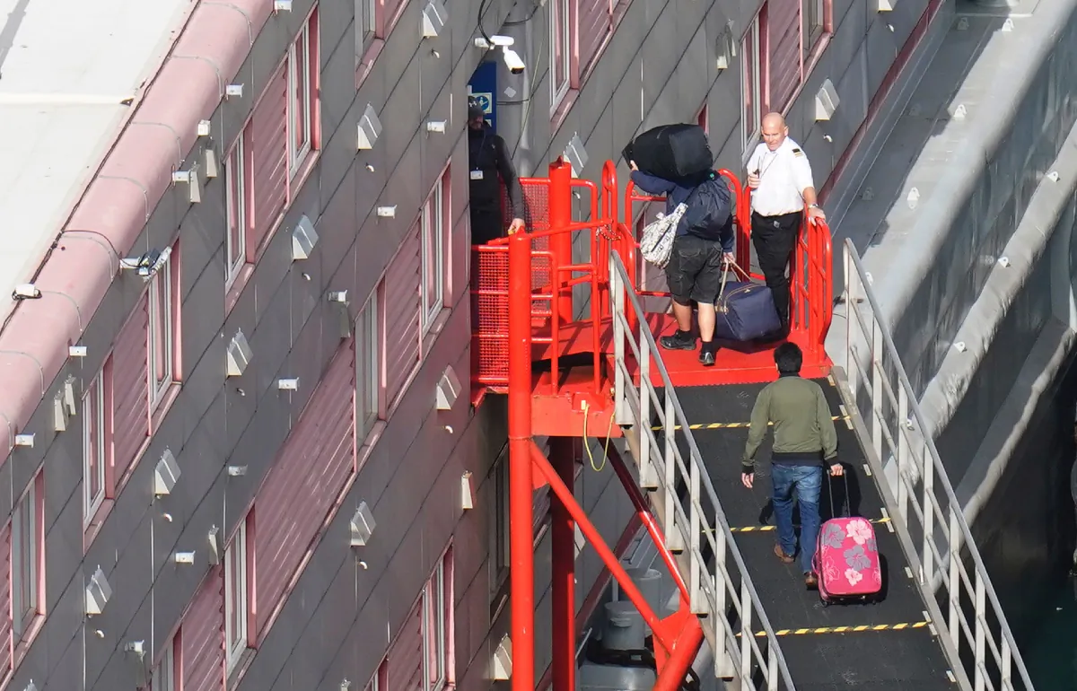 Illegal immigrants board the Bibby Stockholm accommodation barge at Portland Port in Dorset on Oct. 18, 2023. The facility has been out of use since August following the discovery of Legionella bacteria in the water supply. (PA Media)