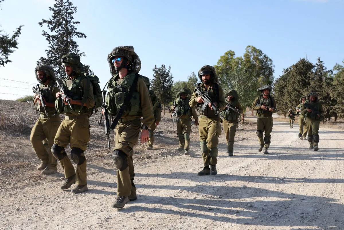 Israeli troops patrol at an undisclosed location along the border with the Gaza Strip on Oct. 19, 2023. (Jack Guez/AFP via Getty Images)