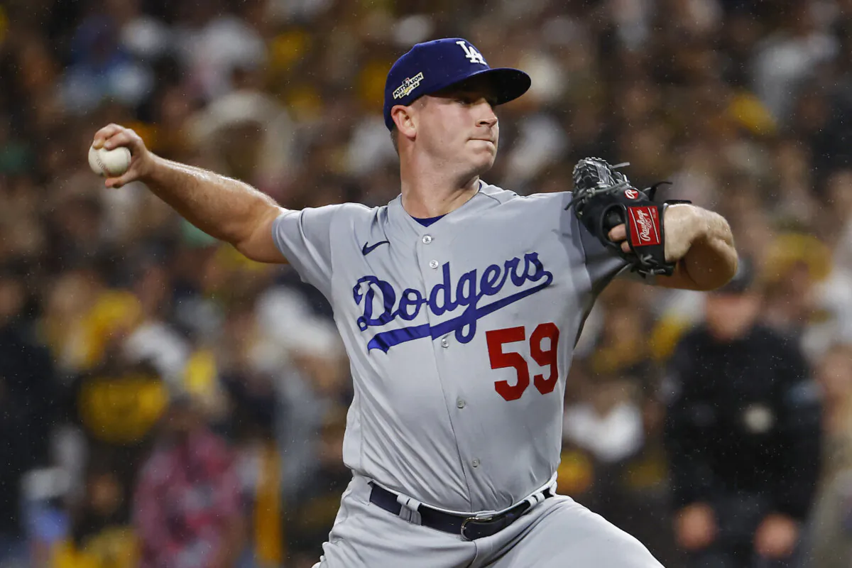 Evan Phillips #59 of the Los Angeles Dodgers pitches during the ninth inning against the San Diego Padres in game four of the National League Division Series at PETCO Park in San Diego on Oct. 15, 2022. (Ronald Martinez/Getty Images)