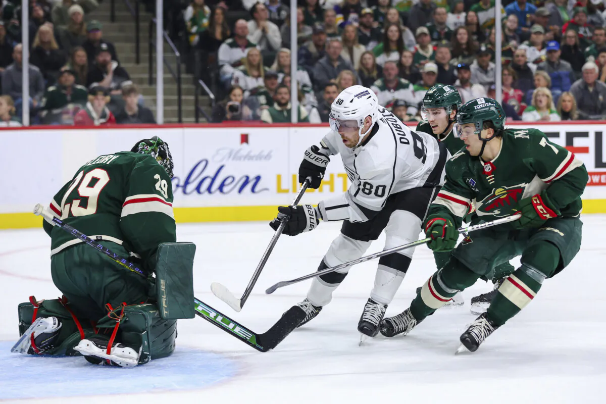 Los Angeles Kings center Pierre-Luc Dubois (white) scores a goal against Minnesota Wild goaltender Marc-Andre Fleury (29) while Wild defenseman Brock Faber (7) defends during the first period of an NHL hockey game in in St. Paul, Minn., on Oct. 19, 2023. (Matt Krohn/AP Photo)