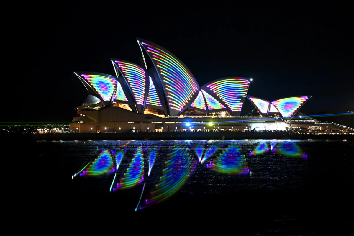 Laser beams are projected as part of an audio-visual laser show to celebrate the 50th anniversary of the Sydney Opera House in Sydney, Oct. 20, 2023. The Sydney Opera House marks its 50th anniversary as high-powered laser beams fill the night sky - dancing along the architecture in a celebratory fashion. (AAP Image/Dan Himbrechts)