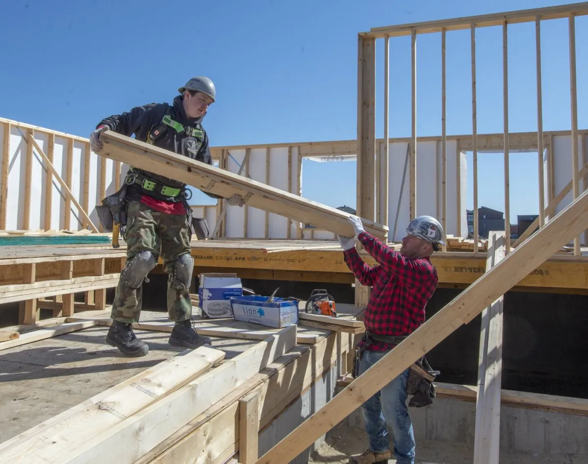 Construction workers work on a home in Deux-Montagnes, Que., on April 20, 2020. (The Canadian Press/Ryan Remiorz)