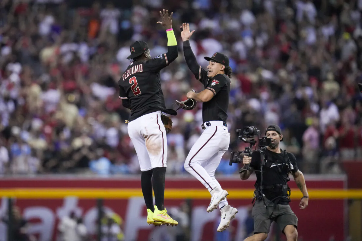 Arizona Diamondbacks center fielder Alek Thomas and shortstop Geraldo Perdomo celebrates their win against the Philadelphia Phillies in Game 4 of the baseball NL Championship Series in Phoenix on Oct. 20, 2023. (Ross D. Franklin/AP Photo)