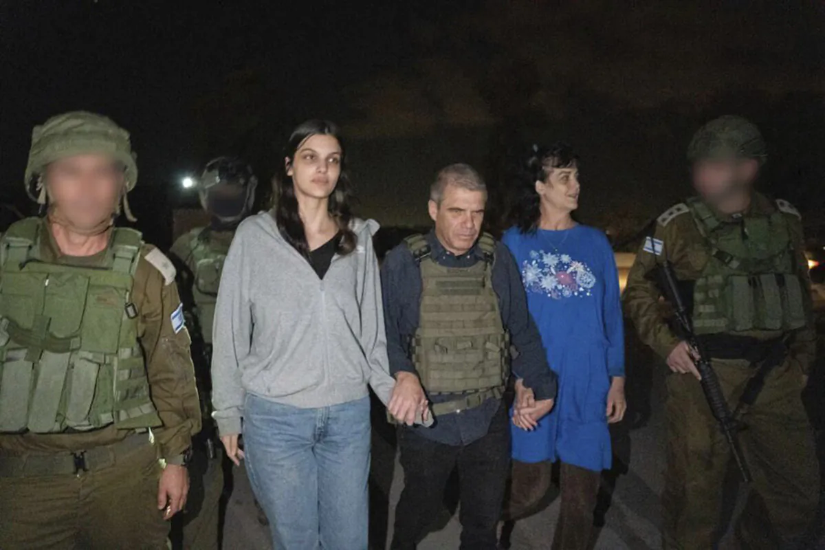 Judith Raanan, right, and her 17-year-old daughter Natalie are escorted by Israeli soldiers and Gal Hirsch, Prime Minister Benjamin Netanyahu's special coordinator for returning the hostages, as they return to Israel from captivity in the Gaza Strip, on Oct. 20, 2023. (Government of Israel via AP Photo)