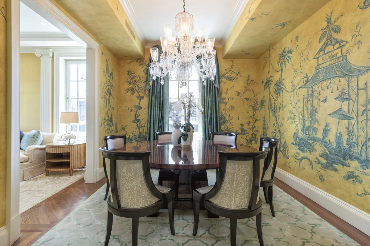 A glossy wood round table and elegant chairs helps to create a formal and luxurious feel in this dining space. (Handout/TNS)