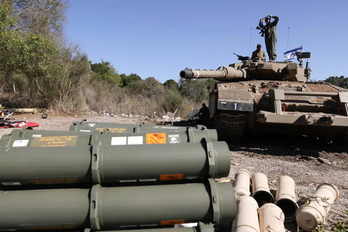 Israeli soldiers sit on a Merkava tank as they man a position at an undisclosed location on the border with Lebanon on Oct. 21, 2023. (Jalaa Marey/AFP via Getty Images)