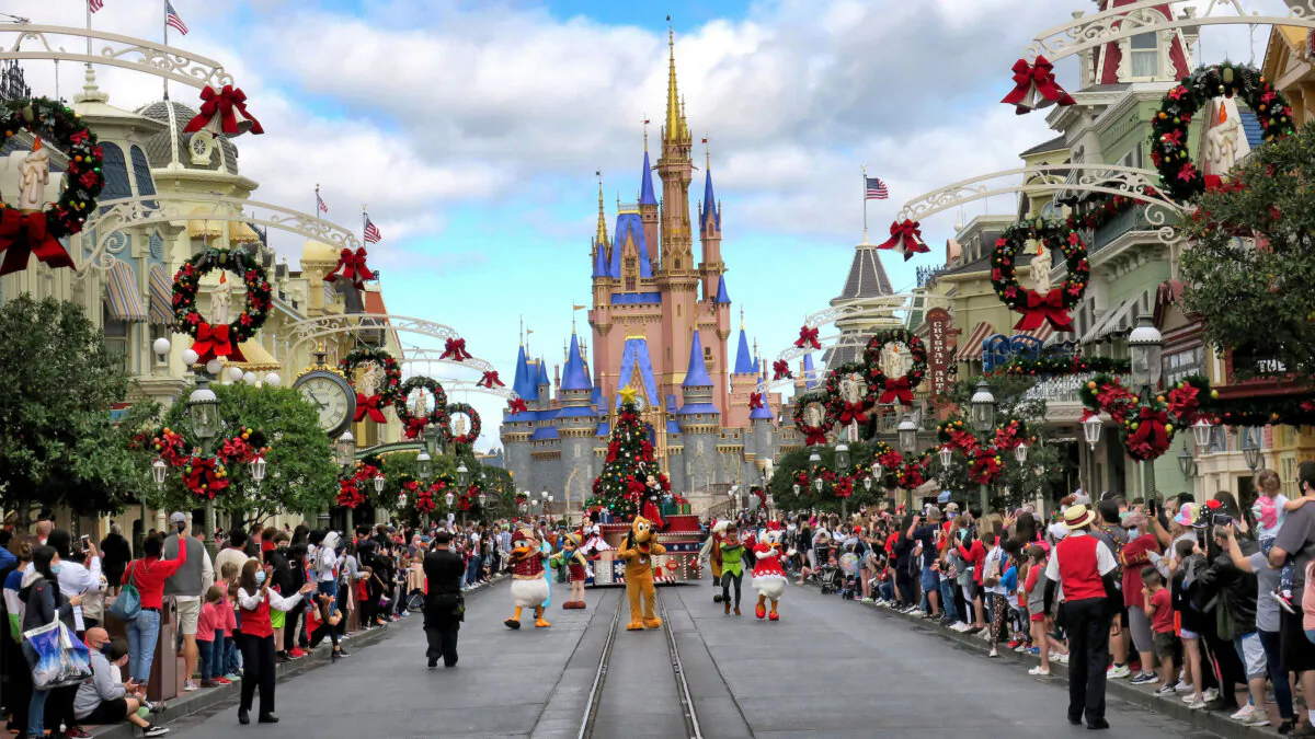 Crowds line Main Street USA, with Cinderella Castle on the horizon, at the Magic Kingdom at Walt Disney World, in Lake Buena Vista, Fla. (TNS)