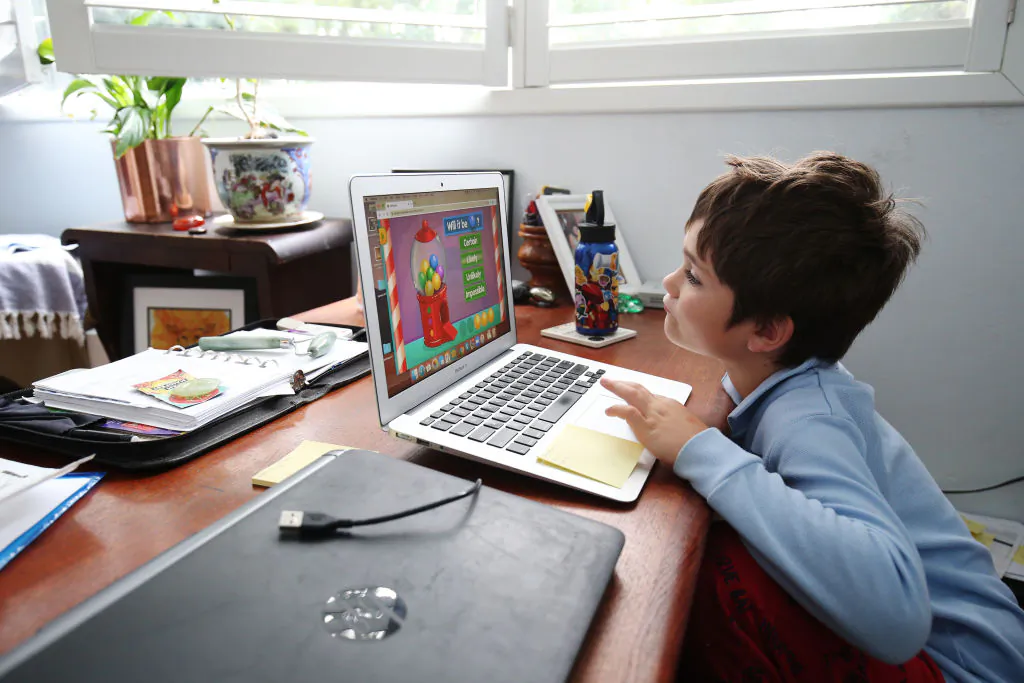 A student does school work on a laptop while being home-schooled in Sydney, Australia, on April 9, 2020. (Brendon Thorne/Getty Images)