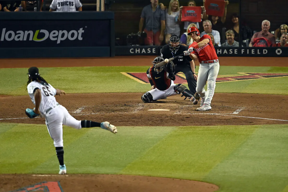J.T. Realmuto (10) of the Philadelphia Phillies hits a two run home run against Luis Frias (65) of the Arizona Diamondbacks during the eighth inning in Game Five of the National League Championship Series at Chase Field in Phoenix on Oct. 21, 2023. (Norm Hall/Getty Images)