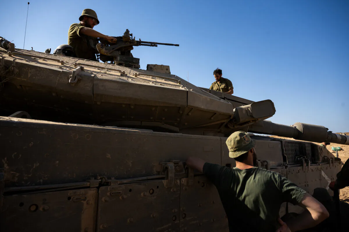 Israel Defense Forces soldiers clean parts of a  tank in Southern Israel, on Oct. 21, 2023. (Alexi J. Rosenfeld/Getty Images)