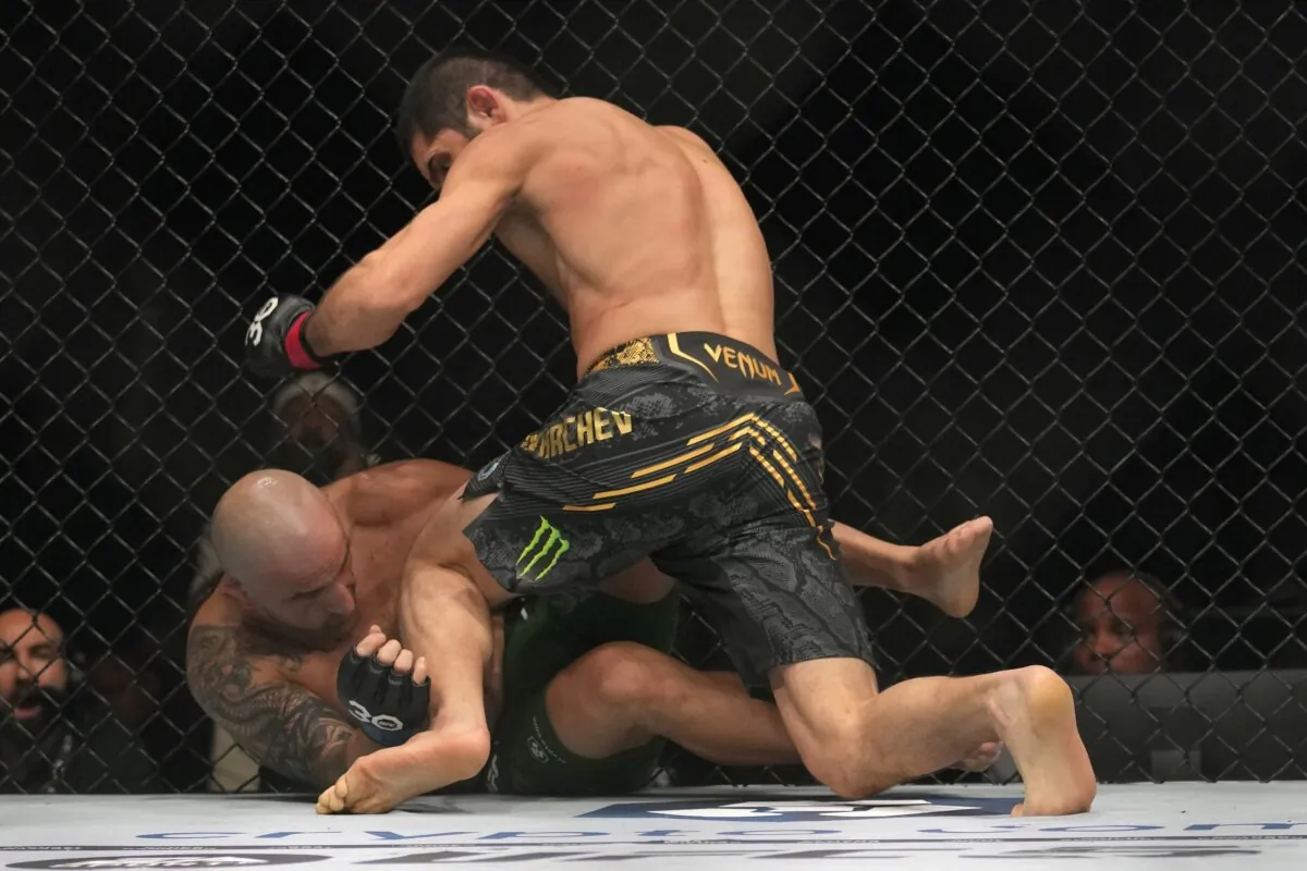 Islam Makhachev of Russia (top) battles Alex Volkanovski of Australia in the UFC lightweight championship fight during UFC 294, mixed martial arts fights at the Ethihad Arena in Abu Dhabi, United Arab Emirates, on Oct. 21, 2023. (Kamran Jebreili/AP Photo)