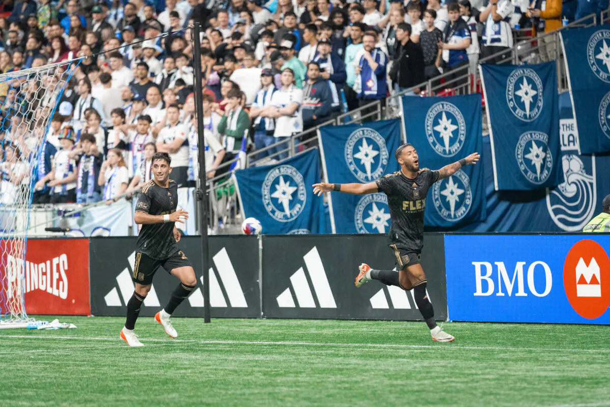 Los Angeles FC forward Denis Bouanga (99) celebrates his goal with teammate after scoring a goal in a match against the Vancouver Whitecaps FC at BC Place in Vancouver, British Columbia, Canada, on Oct 21, 2023. (Courtesy of LAFC via The Epoch Times)