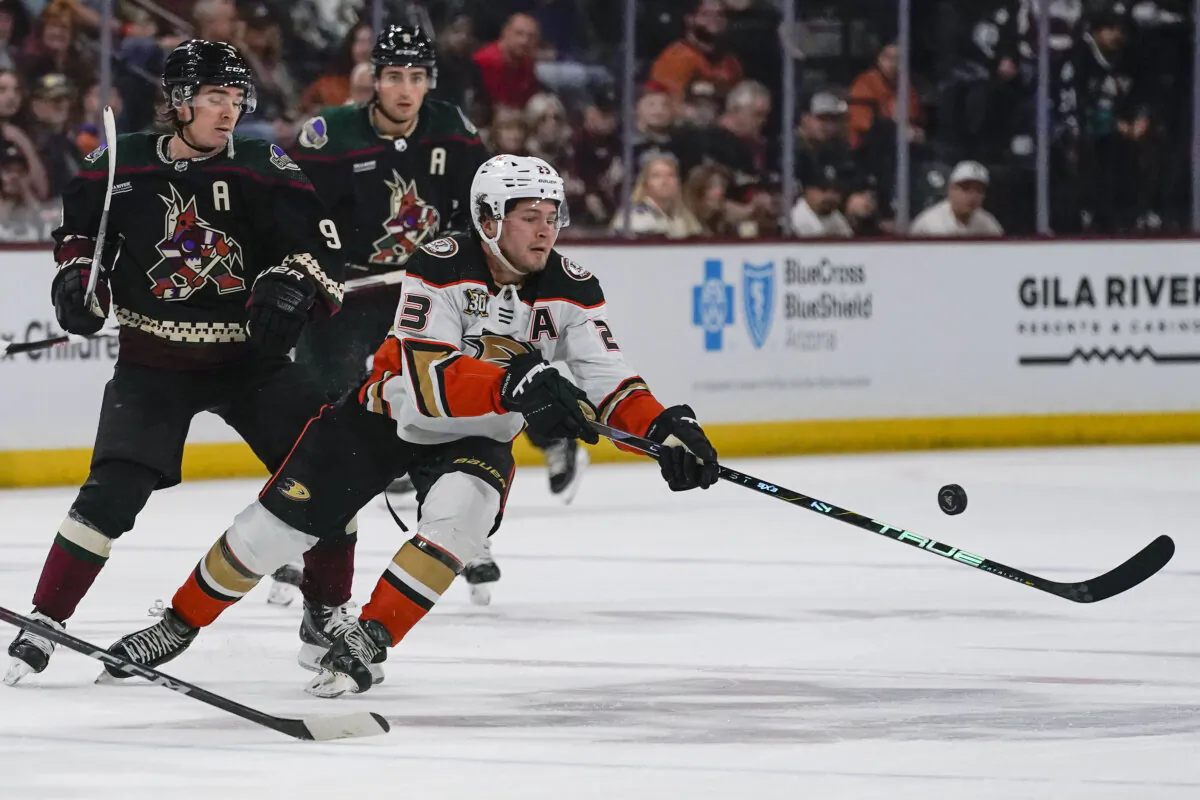 Anaheim Ducks' Mason McTavish (23) reaches for the puck in front of Arizona Coyotes' Clayton Keller (9) during the second period of an NHL hockey game in Tempe, Ariz., on Oct. 21, 2023. (Darryl Webb/AP Photo)
