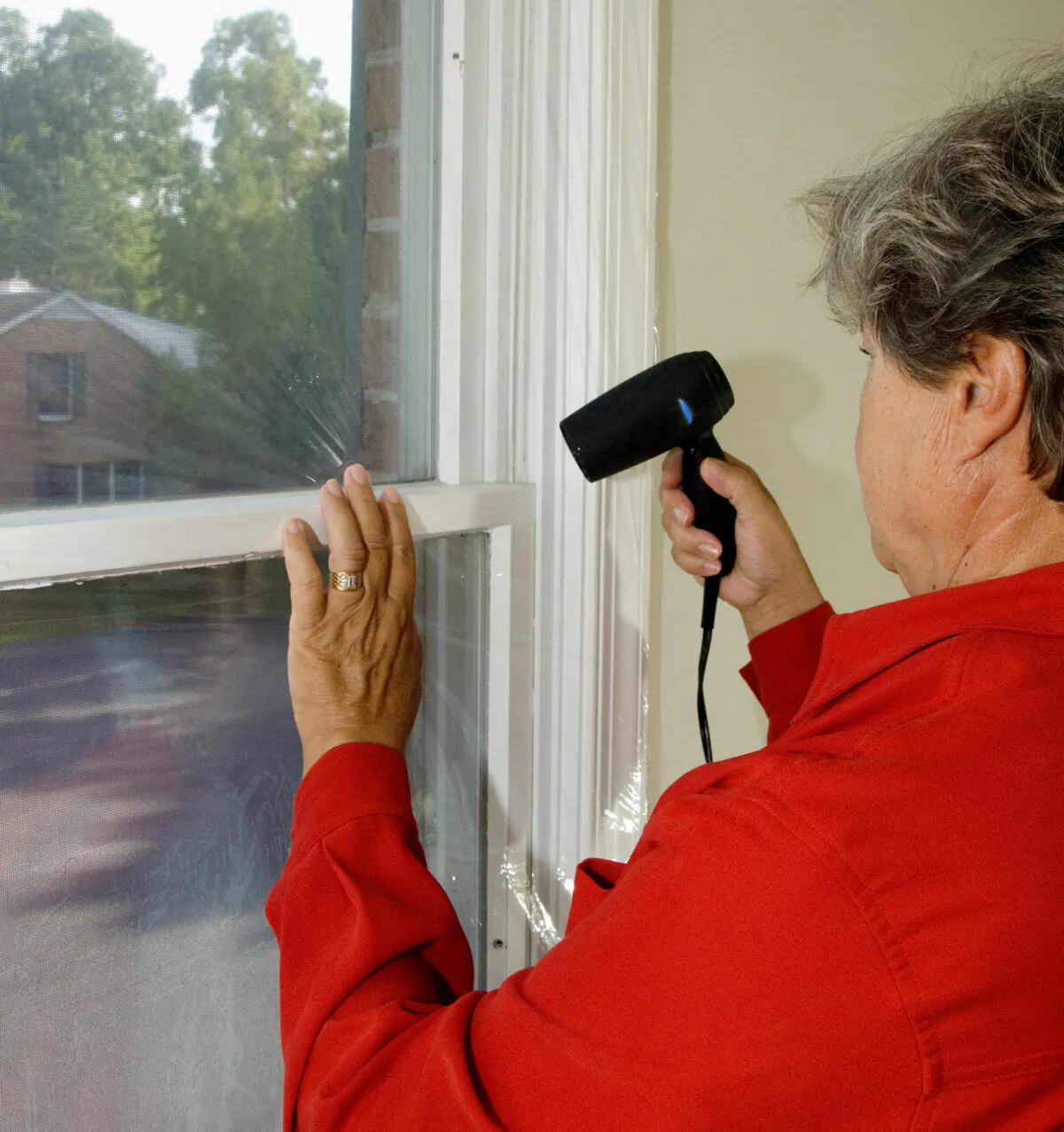 The blast of hot air from the dryer creates a shrink-wrap that seals the window from inside and creates a clear, tight-fitting film. (Gene Hamilton/TNS)