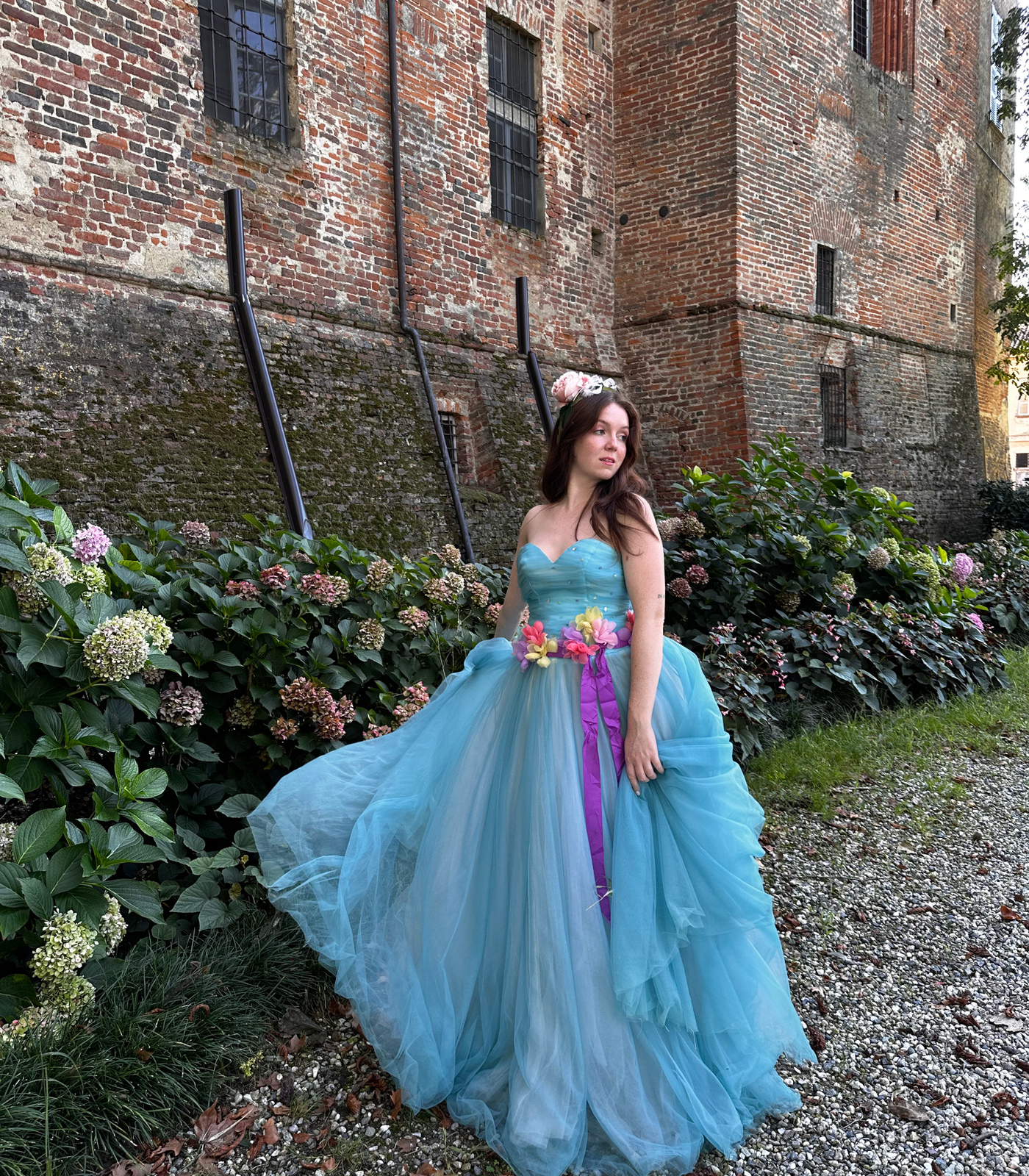 Ludovica Sannazzaro dons one of the extravagant gowns and poses for a picture outside the castle.