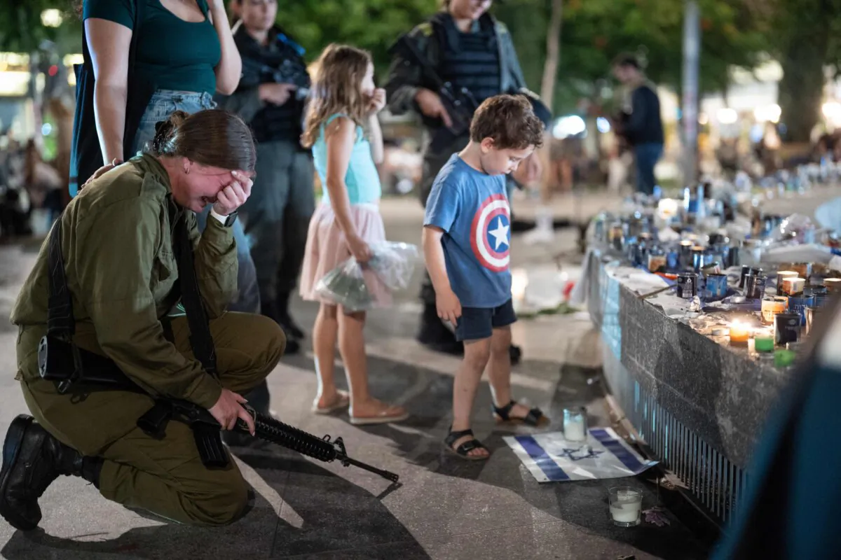 People gather and light candles to remember the victims who were murdered by Hamas terrorists at Dizengoff Square in Tel Aviv, on Oct. 22, 2023. (Dima Vazinovich/Middle East Images/Middle East Images via AFP via Getty Images)