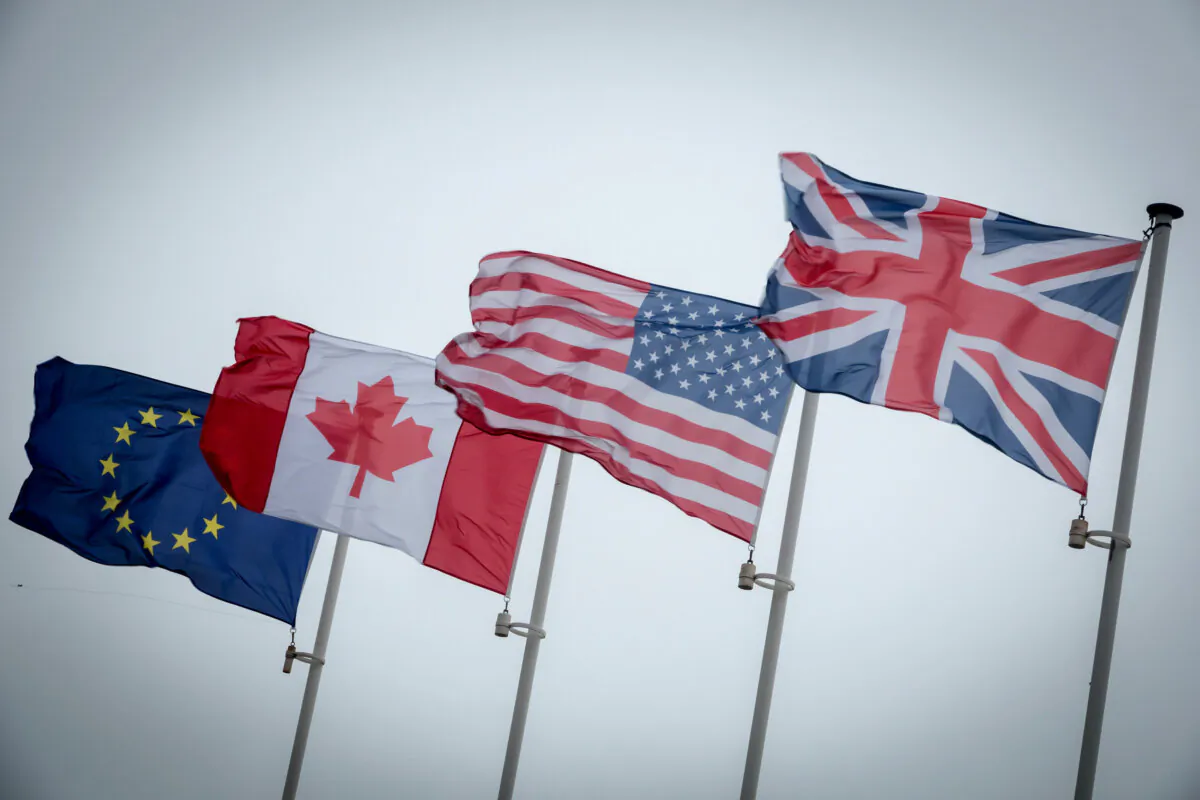 The flags of the United Kingdom, United States, Canada, and the European Union fly over Sword Beach in Colleville-Montgomery, on June 5, 2018 near Caen, France. (Matt Cardy/Getty Images)