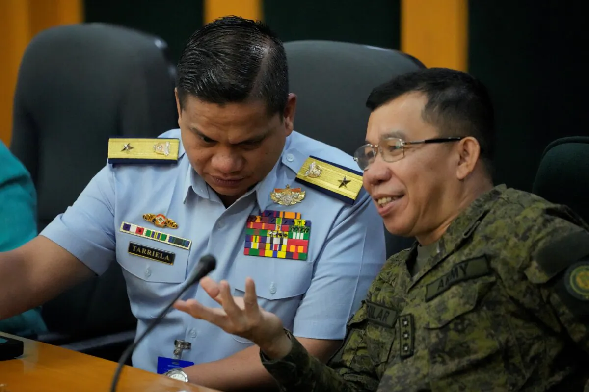 Philippine Coast Guard spokesperson, Commodore Jay Tarriela (L), talks with Armed Forces of the Philippines spokesperson Col. Medel Aguilar during a press conference on a recent incident with Chinese ships at the Second Thomas Shoal as they talk with reporters in Quezon City, Philippines, on Oct. 23, 2023. (Aaron Favila/AP Photo)