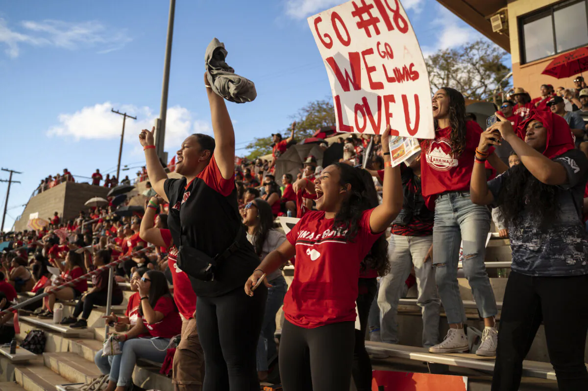 Lahainaluna High School football fans cheer for the junior varsity team at Sue D. Cooley Stadium in Lahaina, Hawaii, on Oct. 21, 2023. (Mengshin Lin/AP Photo)