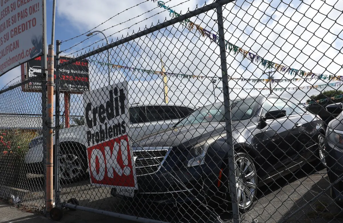 A sign about credit requirements is displayed at Amigos Auto Sales in Richmond, Calif., on Sept. 06, 2023. (Justin Sullivan/Getty Images)