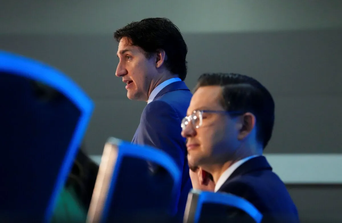 Prime Minister Justin Trudeau and Conservative Leader Pierre Poilievre take part in the National Prayer Breakfast in Ottawa on May 30, 2023. (The Canadian Press/Sean Kilpatrick)