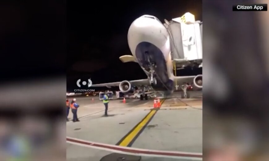 JetBlue plane tilts back as passengers disembark at JFK Airport.