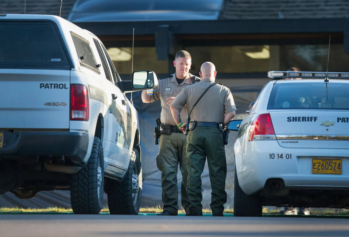 Police officers stand in front of Snyder Hall on the campus of Umpqua Community College as it reopens in Roseburg, Ore., on Oct. 5, 2015. (Scott Olson/Getty Images)