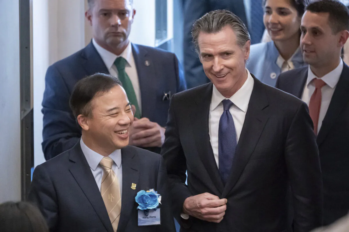 Visiting California Gov. Gavin Newsom (R) and President and Vice-Chancellor of the University of Hong Kong Xiang Zhang (L) arrive at the fireside chat at the Hong Kong University in Hong Kong on Oct. 23, 2023. (Anthony Kwan/AP Photo)