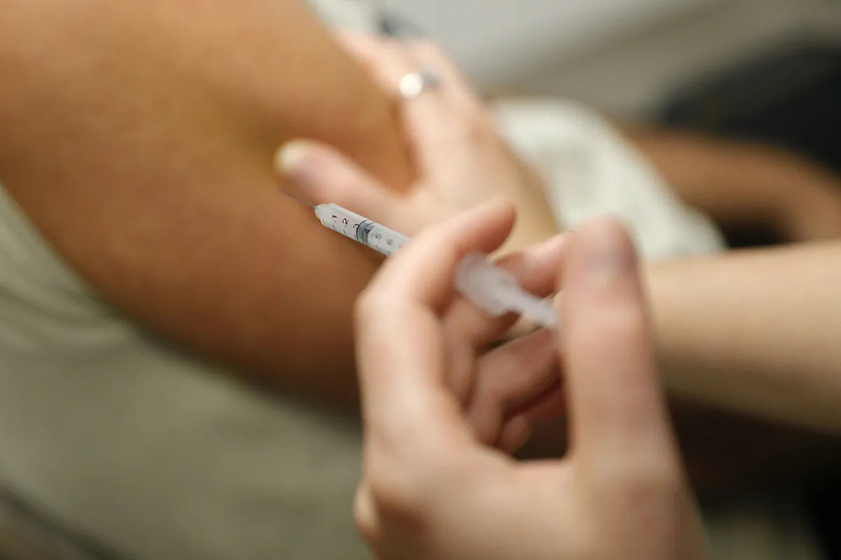 A man receives a dose of Comirnaty Omicron XBB 1.5 Pfizer vaccine in a file image. (Pascal Pochard-Casabianca/AFP via Getty Images)