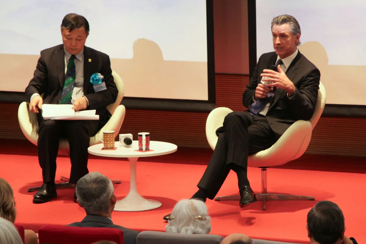 California Gov. Gavin Newsom (R) speaks on the state's experience in combating climate change with professor Gong Peng at the University of Hong Kong, in Hong Kong on Oct. 23, 2023. (Xinqi Su/AFP via Getty Images)